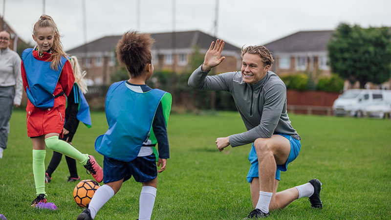 coach gives high fives to players